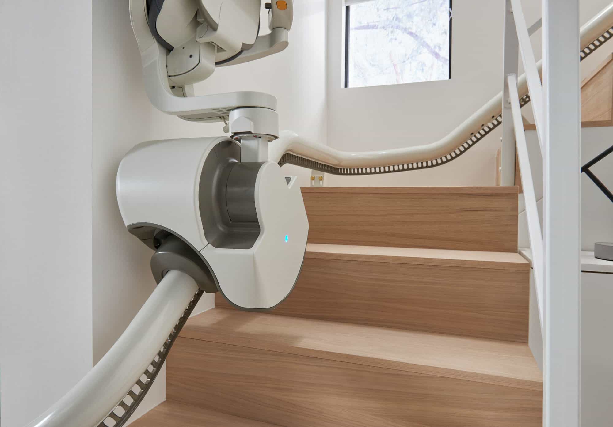 Flow X curved stairlift installed on a modern curved staircase in a home