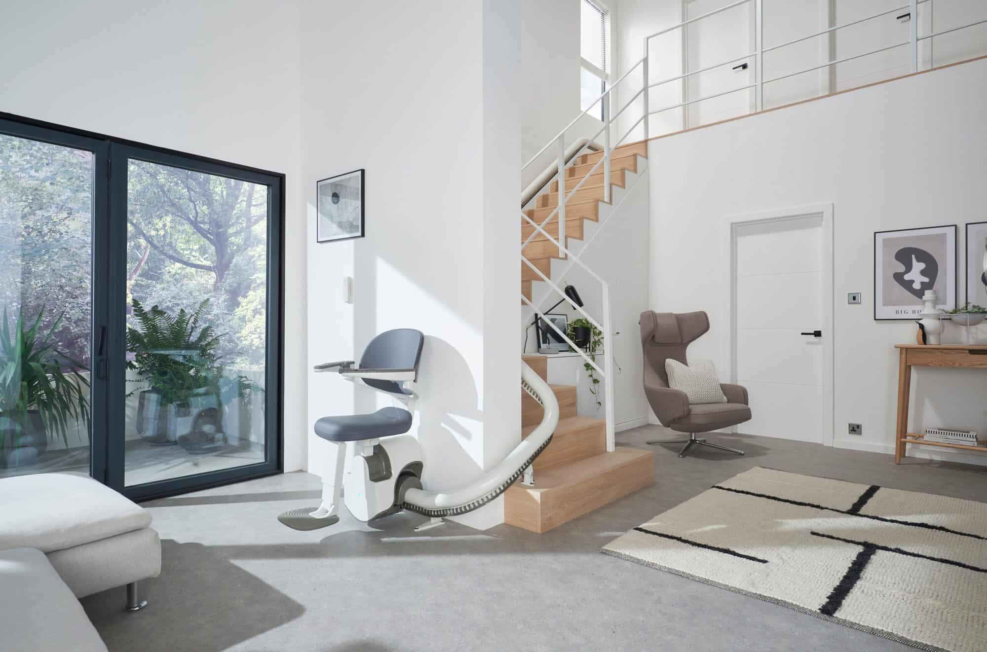 Thyssen stairlift installed on a modern curved staircase in a bright contemporary home