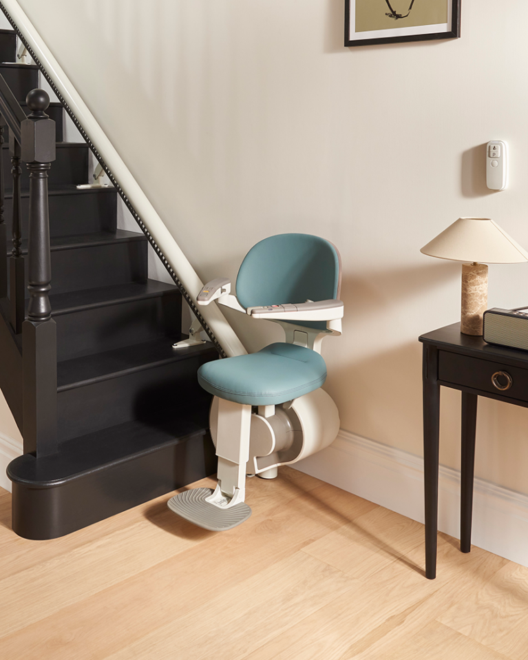 Flow X second hand stairlifts installed on a curved staircase in a modern home