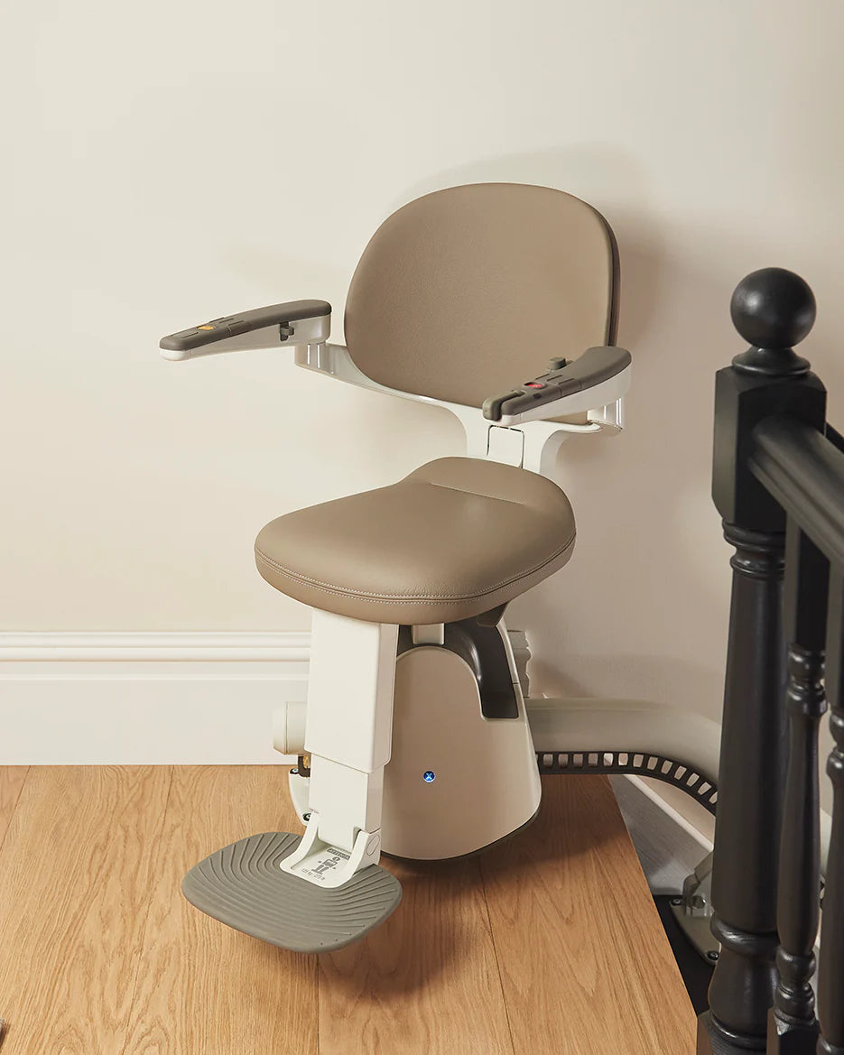 Flow X stairlifts image showing a modern curved stairlift in a home