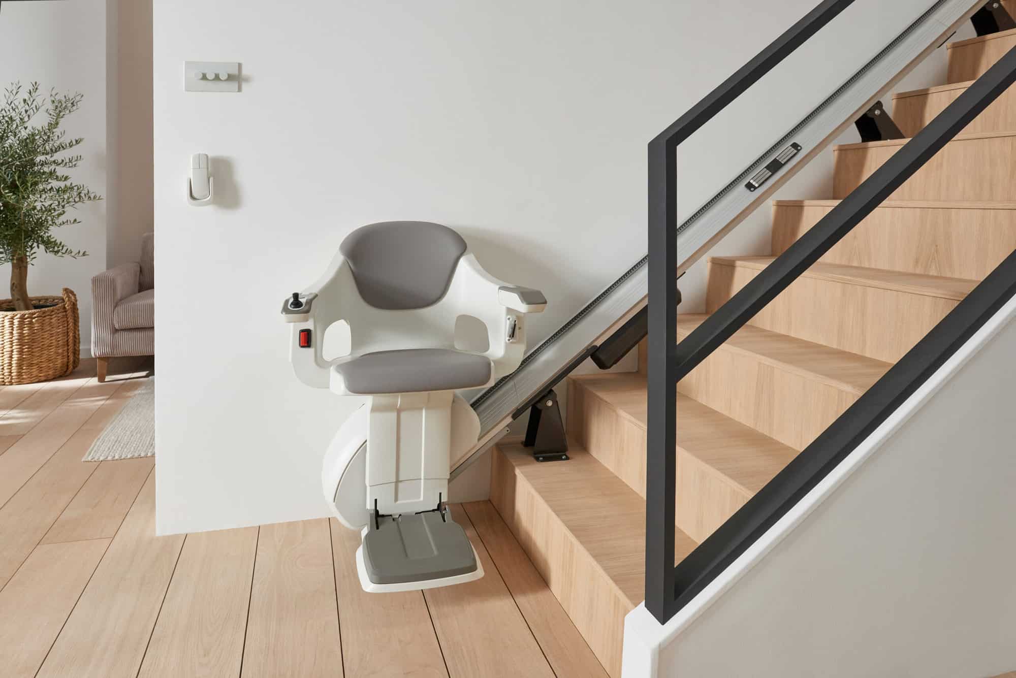 Thyssen HomeGlide stairlifts model installed on a straight staircase in a modern home