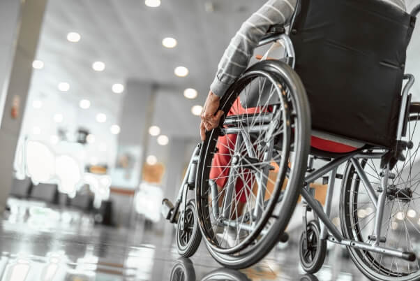 Elderly lady using a wheelchair at airport during her trip. 