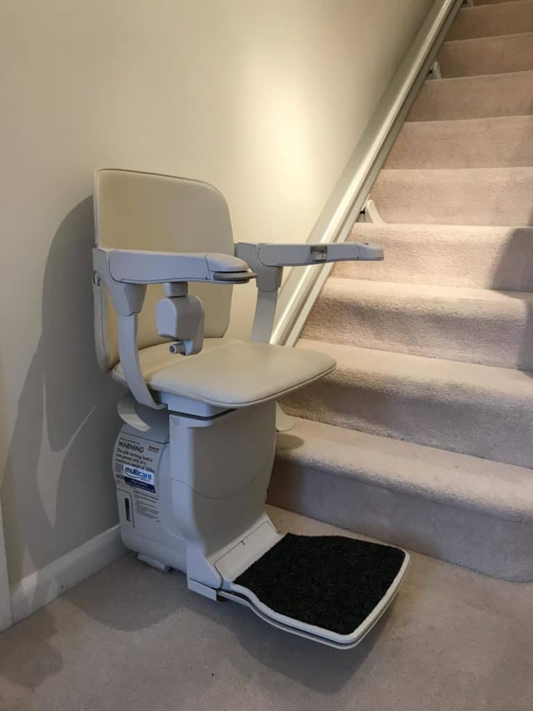 Stannah 600 Stairlift at bottom of the stairs ready to go