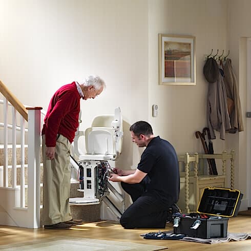 A Man servicing a stairlift