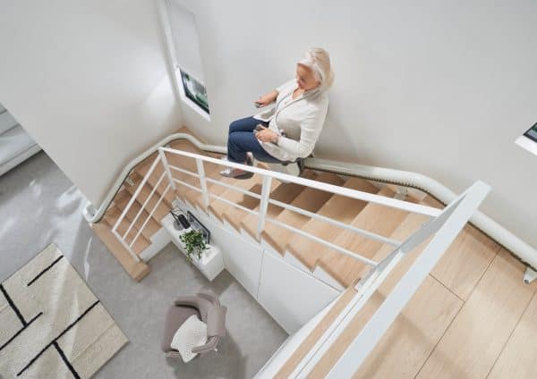 A person goes up the stairs on a Thyssen Flow X Stairlift