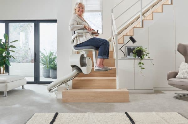 A person goes up the stairs on a Thyssen Flow 2 X Stairlift